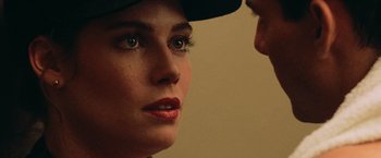 Movie still from “Top Gun” (1986), directed by Tony Scott – A person wearing a hat; Extreme Close Up shot, Over the shoulder angle