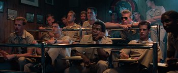 Movie still from “Top Gun” (1986), directed by Tony Scott – A group of men sitting in a classroom; Medium shot, High angle