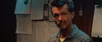 Movie still from “Top Gun” (1986), directed by Tony Scott – A person with a mustache; Close Up shot, Low angle