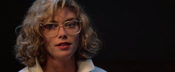 Movie still from “Top Gun” (1986), directed by Tony Scott – A person wearing glasses; Close Up shot, Low angle