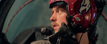 Movie still from “Top Gun” (1986), directed by Tony Scott – A person with a helmet on; Close Up shot, Low angle