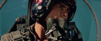 Movie still from “Top Gun” (1986), directed by Tony Scott – A person wearing a helmet; Close Up shot, Low angle