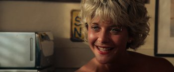 Movie still from “Top Gun” (1986), directed by Tony Scott – A person smiling; Close Up shot, Over the shoulder angle