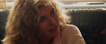 Movie still from “Top Gun” (1986), directed by Tony Scott – A woman with blonde hair; Close Up shot, Over the shoulder angle