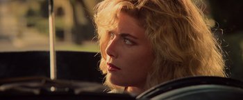 Movie still from “Top Gun” (1986), directed by Tony Scott – A person in a car looking to the side; Close Up shot, Low angle