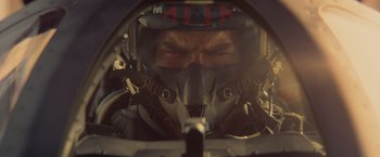 Movie still from “Top Gun” (1986), directed by Tony Scott – A person in a fighter pilot's helmet; Close Up shot, Low angle