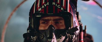 Movie still from “Top Gun” (1986), directed by Tony Scott – A person wearing a helmet; Close Up shot, Low angle