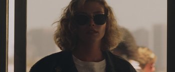 Movie still from “Top Gun” (1986), directed by Tony Scott – A person wearing sunglasses and a leather jacket; Close Up shot, Low angle