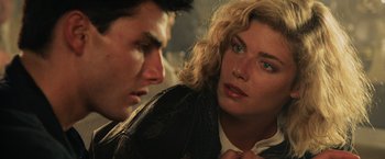 Movie still from “Top Gun” (1986), directed by Tony Scott – A man and a woman looking at one another; Close Up shot, Over the shoulder angle