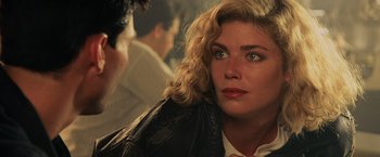 Movie still from “Top Gun” (1986), directed by Tony Scott – A person wearing a leather jacket; Close Up shot, Over the shoulder angle