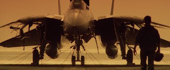 Movie still from “Top Gun” (1986), directed by Tony Scott – View of the underside of an airplane; Wide shot, Low angle