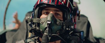 Movie still from “Top Gun” (1986), directed by Tony Scott – A person wearing a helmet; Close Up shot, Low angle