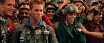 Movie still from “Top Gun” (1986), directed by Tony Scott – A group of men in flight suits and helmets; Close Up shot, Low angle
