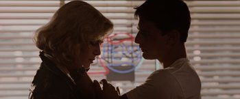 Movie still from “Top Gun” (1986), directed by Tony Scott – A man and a woman are looking at one another; Close Up shot, Over the shoulder angle