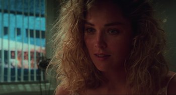 Movie still from “Total Recall” (1990), directed by Paul Verhoeven – A person with curly blonde hair; Close Up shot, Over the shoulder angle