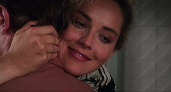 Movie still from “Total Recall” (1990), directed by Paul Verhoeven – A person hugging another person; Close Up shot, Over the shoulder angle