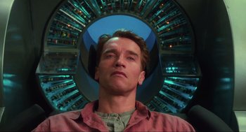 Movie still from “Total Recall” (1990), directed by Paul Verhoeven – A person in a red shirt; Close Up shot, Low angle