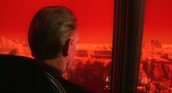 Movie still from “Total Recall” (1990), directed by Paul Verhoeven – A man looking out of a window at a city skyline; Close Up shot, Over the shoulder angle