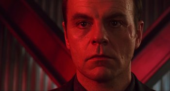 Movie still from “Total Recall” (1990), directed by Paul Verhoeven – A man's face in red light; Close Up shot, Low angle