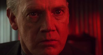 Movie still from “Total Recall” (1990), directed by Paul Verhoeven – A man's face in red light; Close Up shot, Low angle