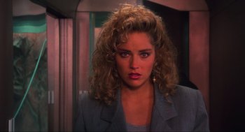 Movie still from “Total Recall” (1990), directed by Paul Verhoeven – A person with curly hair; Close Up shot, Over the shoulder angle