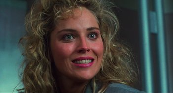 Movie still from “Total Recall” (1990), directed by Paul Verhoeven – A person with long blonde hair; Close Up shot, Over the shoulder angle