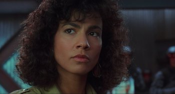 Movie still from “Total Recall” (1990), directed by Paul Verhoeven – A person with curly hair; Close Up shot, Low angle