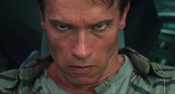 Movie still from “Total Recall” (1990), directed by Paul Verhoeven – A man's face with green eyes; Close Up shot, Low angle