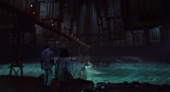 Movie still from “Total Recall” (1990), directed by Paul Verhoeven – A couple of people standing next to each other in the water; Wide shot, Low angle