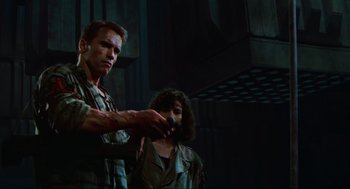 Movie still from “Total Recall” (1990), directed by Paul Verhoeven – A man and a woman are holding a knife; Medium shot, Low angle