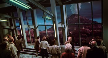 Movie still from “Total Recall” (1990), directed by Paul Verhoeven – A group of people standing in front of a large window; Extreme Wide shot, High angle