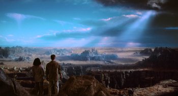 Movie still from “Total Recall” (1990), directed by Paul Verhoeven – Two people standing on top of a hill looking at a painting; Extreme Wide shot, High angle