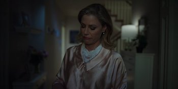 Movie still from “Totally Killer” (2023), directed by Nahnatchka Khan – A woman in a pink robe looking down at the floor; Medium shot, Low angle