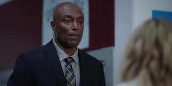 Movie still from “Totally Killer” (2023), directed by Nahnatchka Khan – A man in a suit and tie looking at a mirror; Close Up shot, Over the shoulder angle