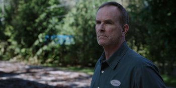 Movie still from “Totally Killer” (2023), directed by Nahnatchka Khan – A person wearing a button up shirt; Close Up shot, Over the shoulder angle