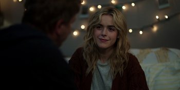 Movie still from “Totally Killer” (2023), directed by Nahnatchka Khan – A woman sitting next to a man in front of lights; Close Up shot, Over the shoulder angle