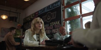 Movie still from “Totally Killer” (2023), directed by Nahnatchka Khan – A woman sitting at a table in front of a man; Medium shot, Over the shoulder angle