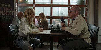 Movie still from “Totally Killer” (2023), directed by Nahnatchka Khan – A group of people sitting at a table; Medium shot, Over the shoulder angle