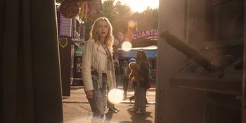 Movie still from “Totally Killer” (2023), directed by Nahnatchka Khan – A woman standing on the sidewalk near a street; Medium shot, Over the shoulder angle