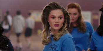 Movie still from “Totally Killer” (2023), directed by Nahnatchka Khan – A young woman with long blonde hair wearing a blue t - shirt; Close Up shot, Over the shoulder angle