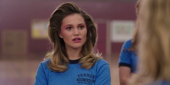 Movie still from “Totally Killer” (2023), directed by Nahnatchka Khan – A woman with long blonde hair wearing a blue t - shirt; Close Up shot, Over the shoulder angle