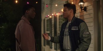 Movie still from “Totally Killer” (2023), directed by Nahnatchka Khan – Two young men are standing outside talking to each other; Medium shot, Over the shoulder angle