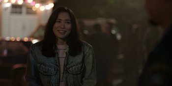 Movie still from “Totally Killer” (2023), directed by Nahnatchka Khan – A woman in a denim jacket smiling for the camera; Close Up shot, Over the shoulder angle