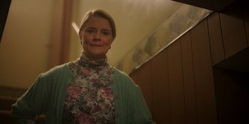 Movie still from “Totally Killer” (2023), directed by Nahnatchka Khan – A woman standing in front of a stair case; Medium shot, Low angle