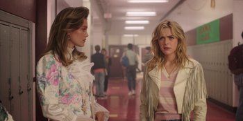 Movie still from “Totally Killer” (2023), directed by Nahnatchka Khan – Two women standing next to each other in a hallway; Medium shot, Over the shoulder angle