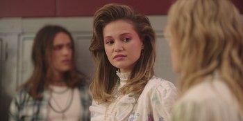 Movie still from “Totally Killer” (2023), directed by Nahnatchka Khan – A woman with long blonde hair wearing a white dress; Close Up shot, Over the shoulder angle