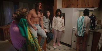 Movie still from “Totally Killer” (2023), directed by Nahnatchka Khan – A group of people standing in a room; Medium shot, Over the shoulder angle