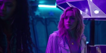 Movie still from “Totally Killer” (2023), directed by Nahnatchka Khan – A woman in a purple room holding an umbrella; Close Up shot, Over the shoulder angle