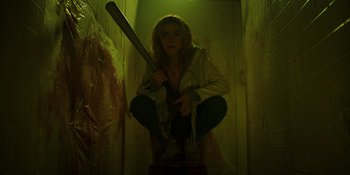 Movie still from “Totally Killer” (2023), directed by Nahnatchka Khan – A woman holding a baseball bat in a dark room; Medium shot, Low angle