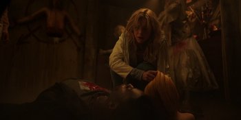 Movie still from “Totally Killer” (2023), directed by Nahnatchka Khan – A woman kneeling down next to a man laying on the ground; Medium shot, Over the shoulder angle